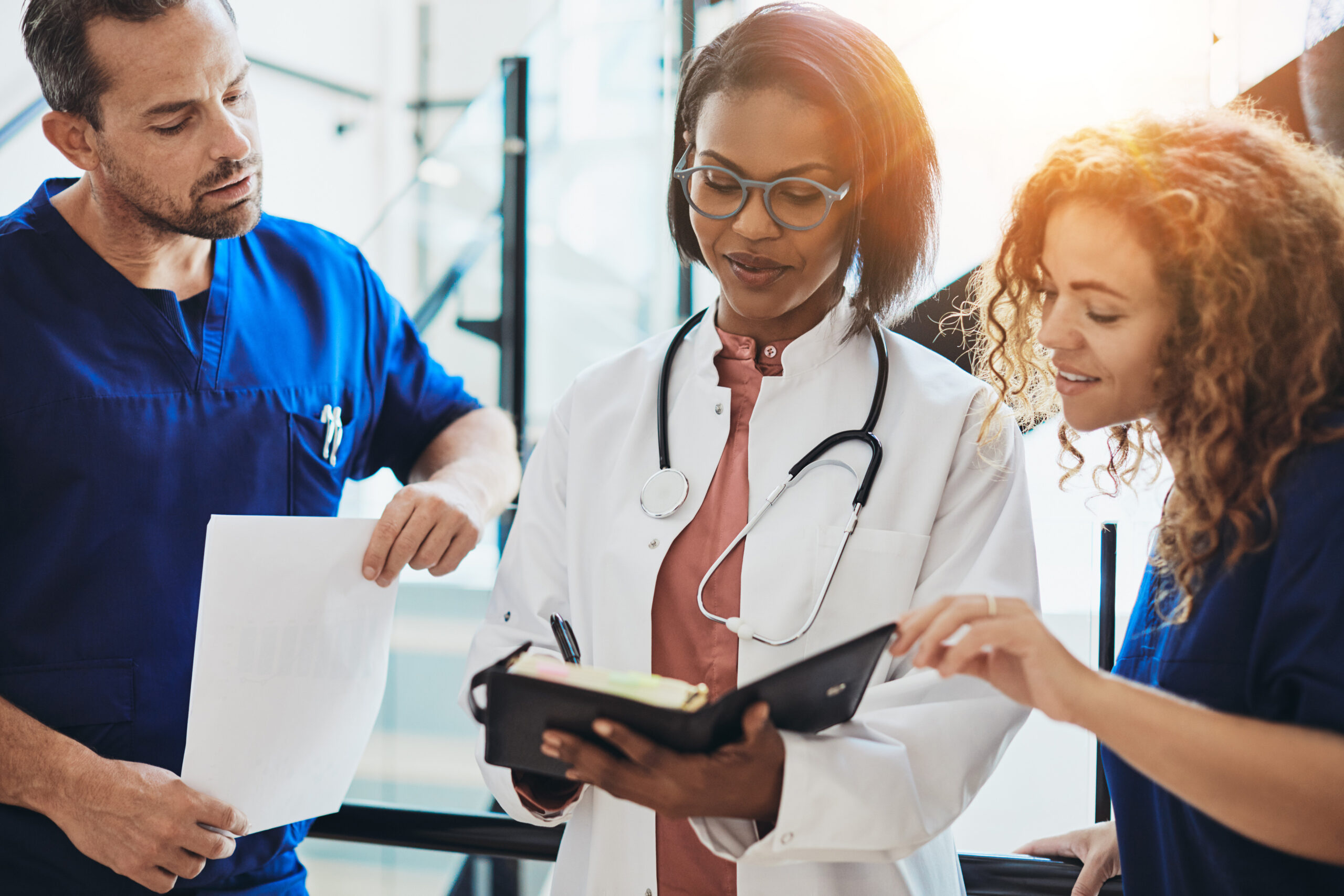 Group of talented, young healthcare professionals reviewing documentation